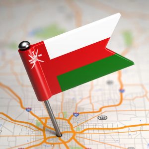 small-flag-oman-map-background-with-selective-focus-min